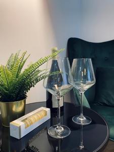 a table with two wine glasses on a table at Wileńska home apartment 3 in Warsaw