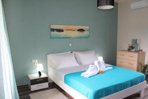 a bedroom with a bed with a flower on it at Kallia's Modern Apartment in Kissamos