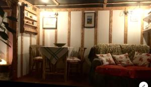 a living room with a table and a couch at Field Hut in Wadebridge