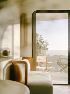 a room with two chairs and a window at Hôtel & Spa Belle Plage in Cannes