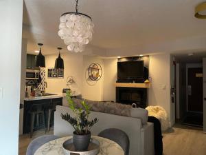 a living room with a couch and a table at Ski-In Ski Out Luxury 1 Bd / 2 ba Condo in Park City