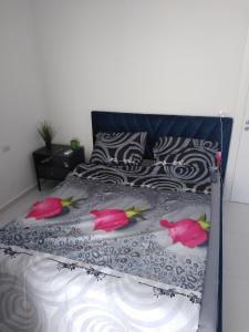 a bed with three pink flamingos on it at Beautiful Sarandë in Sarandë