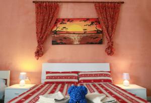 A bed or beds in a room at Appartamenti Blue House