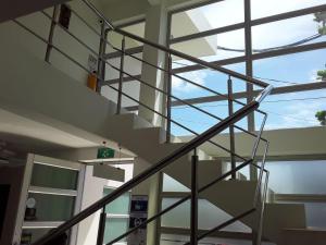 a spiral staircase in a building with a window at ALIIKA HOTEL in Albania