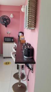 a kitchen with a table with a toaster on it at ALIIKA HOTEL in Albania
