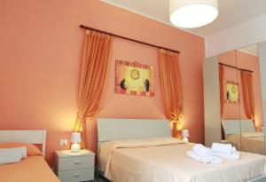 A bed or beds in a room at Appartamenti Blue House