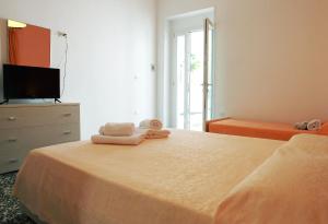A bed or beds in a room at Appartamenti Blue House