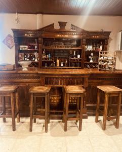 a wooden bar with stools in a room at Mia Volcan in Volcán