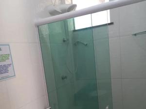 a shower with a glass door in a bathroom at Pousada Vilas Boas in Barreirinhas