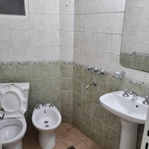 a bathroom with a toilet and a sink at Departamento av.Cordoba in San Juan