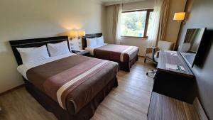 Postel nebo postele na pokoji v ubytování Hotel Diego de Almagro Osorno