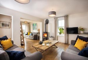 a living room with a couch and a fireplace at Trewalder in St Merryn