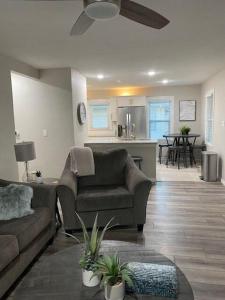 a living room with a couch and a kitchen at Luxurious and peaceful in Topeka