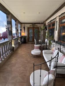 a room with chairs and tables on a balcony at Tenerife Sur Habitación de Lujo in Adeje