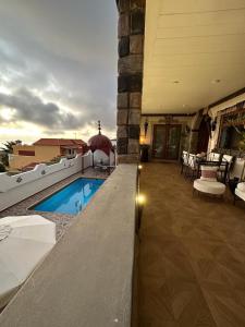 a house with a swimming pool and a patio at Tenerife Sur Habitación de Lujo in Adeje