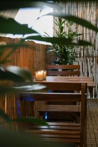 a wooden table with a candle and a plant on it at Quiet City Center Apt on a Pedestrian Street in Athens