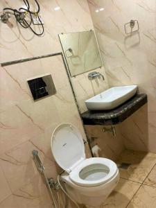 a bathroom with a toilet and a sink at Hotel D Tark Near IGI Airport in New Delhi