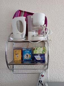a metal shelf with food and a coffee maker on it at Appt 4 pers au Pla d' Adet, Résidence le Grand Stemm , station de ski Saint Lary in Saint-Lary-Soulan