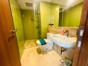 a bathroom with a sink and a toilet and a mirror at Vortex Premium Suites KLCC by SCHIEN in Kuala Lumpur +29 photos