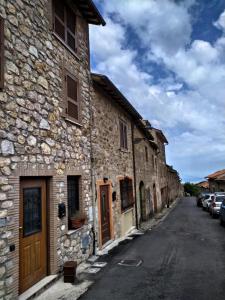 an old stone building on a street at Casetta degli Etruschi in Allumiere