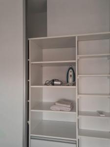 a white closet with white shelves and a toaster at Wasi - El Palomar in El Palomar