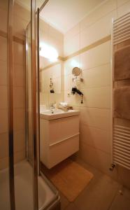 a bathroom with a shower and a sink at Appartementhaus Daniel in Saalbach-Hinterglemm