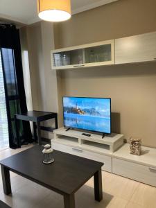 a living room with a large flat screen tv at FOZ II PLAYAS in Foz