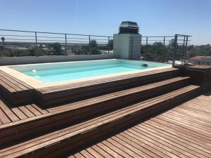 a swimming pool on the roof of a building at El Porteño in San Pedro