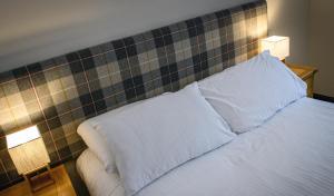 a bedroom with a bed with two pillows on it at The Bridge Helmsdale in Helmsdale