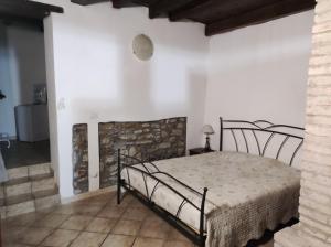 a bedroom with a bed in a white room at La Corte dei Celti in San Benedetto Del Querceto
