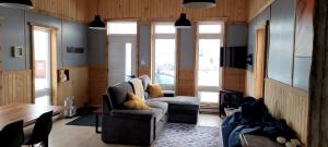 a living room with two chairs and a table at Motel du Haut Phare in Cap-des-Rosiers