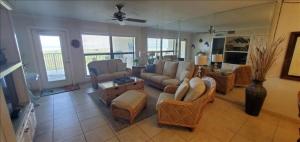 a living room with a couch and chairs and a mirror at Saida I Condos S1206 in South Padre Island