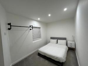 a white bedroom with a bed and a window at Unique New 4 Bedroom House, HS2, Business People, Contractors & Families in Minworth