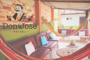 a room with a hammock and a sign that reads don lose trust at Hostal Don Jose in Santa Rosa de Cabal
