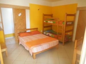 a bedroom with a bed and two bunk beds at Pousada do Ceu in Paul
