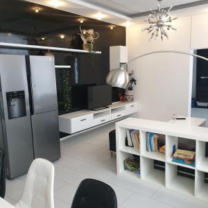 a living room with a refrigerator and a tv at Moderne Wohnung im Zentrum und Alte Wohnung im Zentrum in Eitorf