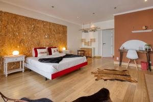 a bedroom with a bed and a wooden wall at Pillows Peniche B&B in Peniche