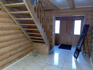 een trap in een kamer met houten wanden bij Meijas Nams in Kalupe