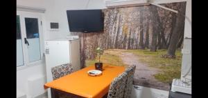 a kitchen with an orange table and a refrigerator at NUESTRO MUNDO TRELEW in Trelew