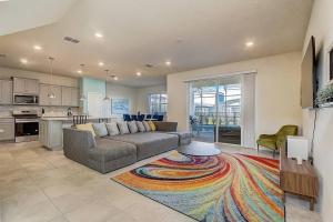 a living room with a couch and a kitchen at luxury new 5 bedroom solterra resort close to disney in Davenport