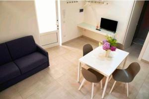 a living room with a table and a couch at SANT'ANTIDA APARTMENT in Caserta