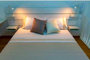 a bed with white sheets and pillows in a room at SANT'ANTIDA APARTMENT in Caserta