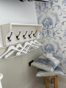 a room with blue and white wallpaper and a stool at Once upon a tide in Kent