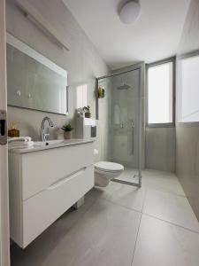 a bathroom with a sink and a toilet and a shower at Amazing 2Rooms Apt in Bat Yam - Step by the beach in Bat Yam