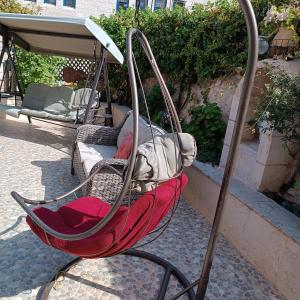 a swing chair sitting on the side of a patio at Abram's appartment in the Center of Bethlehem city in Bethlehem