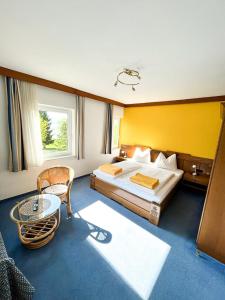 a hotel room with a bed and a table at Seepension Kakl in Velden am Wörthersee