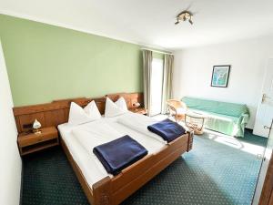 a bedroom with a large bed and a room with a bed sqor at Seepension Kakl in Velden am Wörthersee