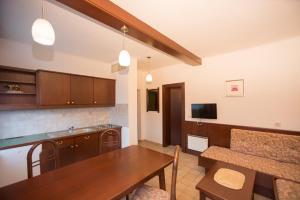 a kitchen and dining room with a wooden table at Seepension Kakl in Velden am Wörthersee