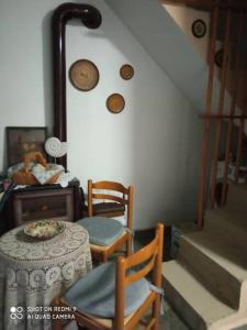 a room with a table and chairs and stairs at Persefoni's Traditional House in Promírion