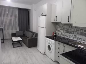 a kitchen and living room with a couch and a refrigerator at *Новая квартира 1+1 Mecidiyeköy in Istanbul